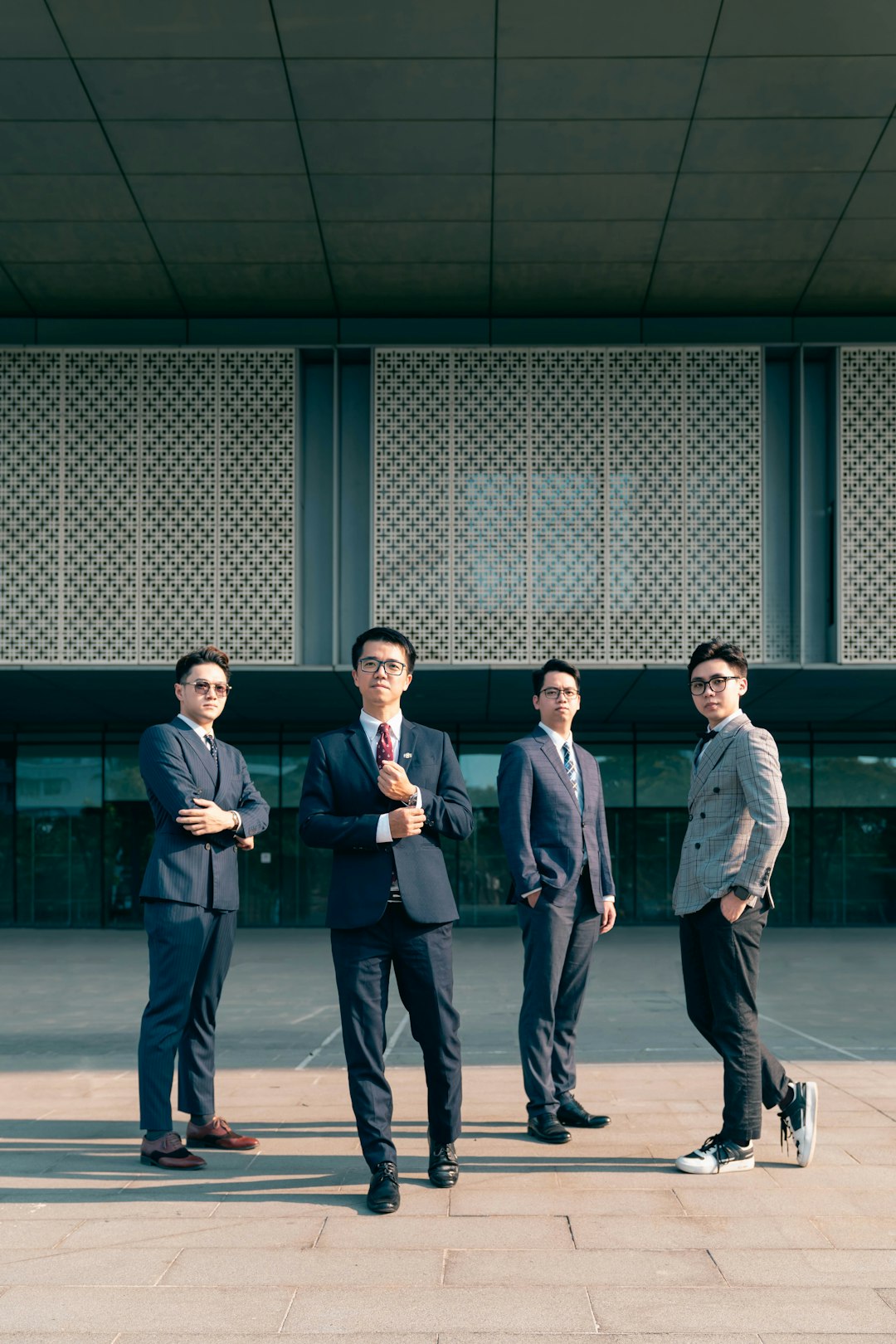 a-group-of-men-standing-in-front-of-a-building-vid5qaurna8